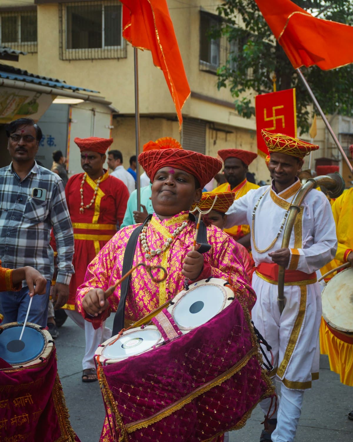 A drummer leading a procession with flags